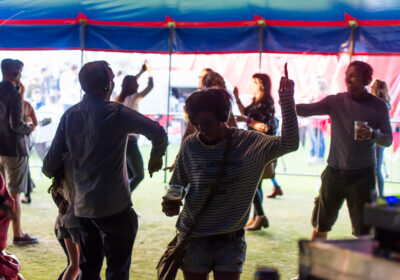 People dance while listening to headphones in a festival tent at Head For The Hills